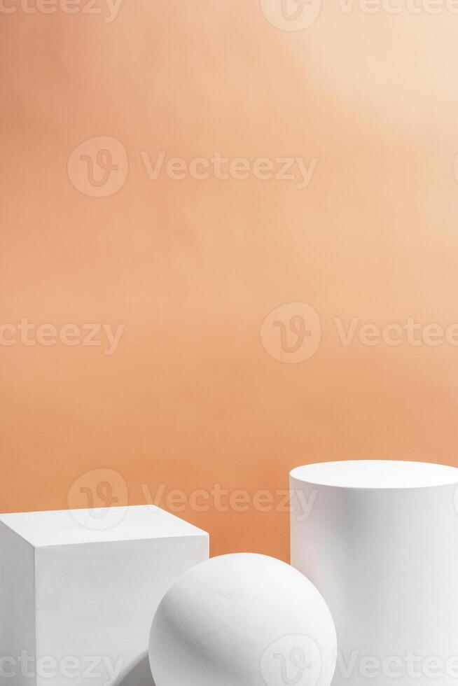 White geometric shapes arranged stylishly on a soft peach background in a minimalist setting photo