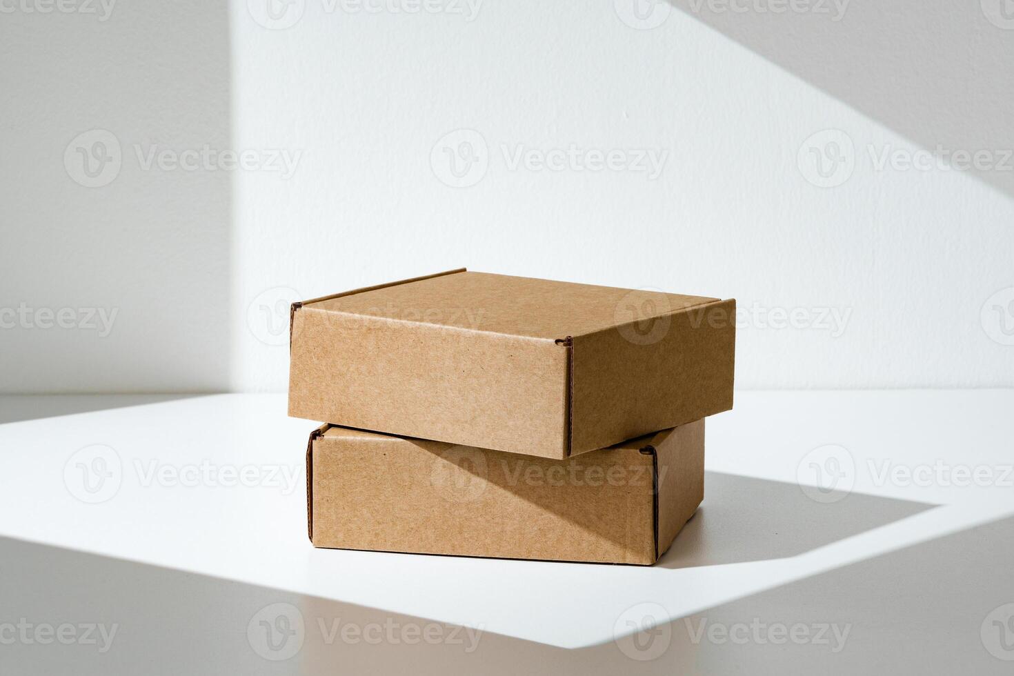Freshly packed cardboard boxes resting on a white surface, illuminated by soft natural light photo
