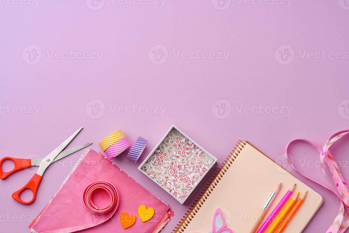 Crafting supplies on a purple background ready for creative projects photo