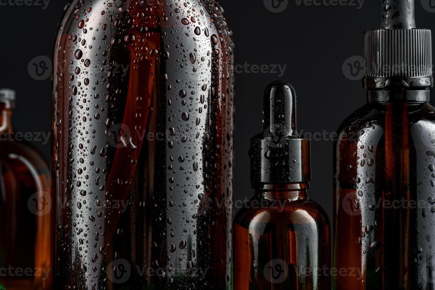 Dark glass bottle on a black background photo