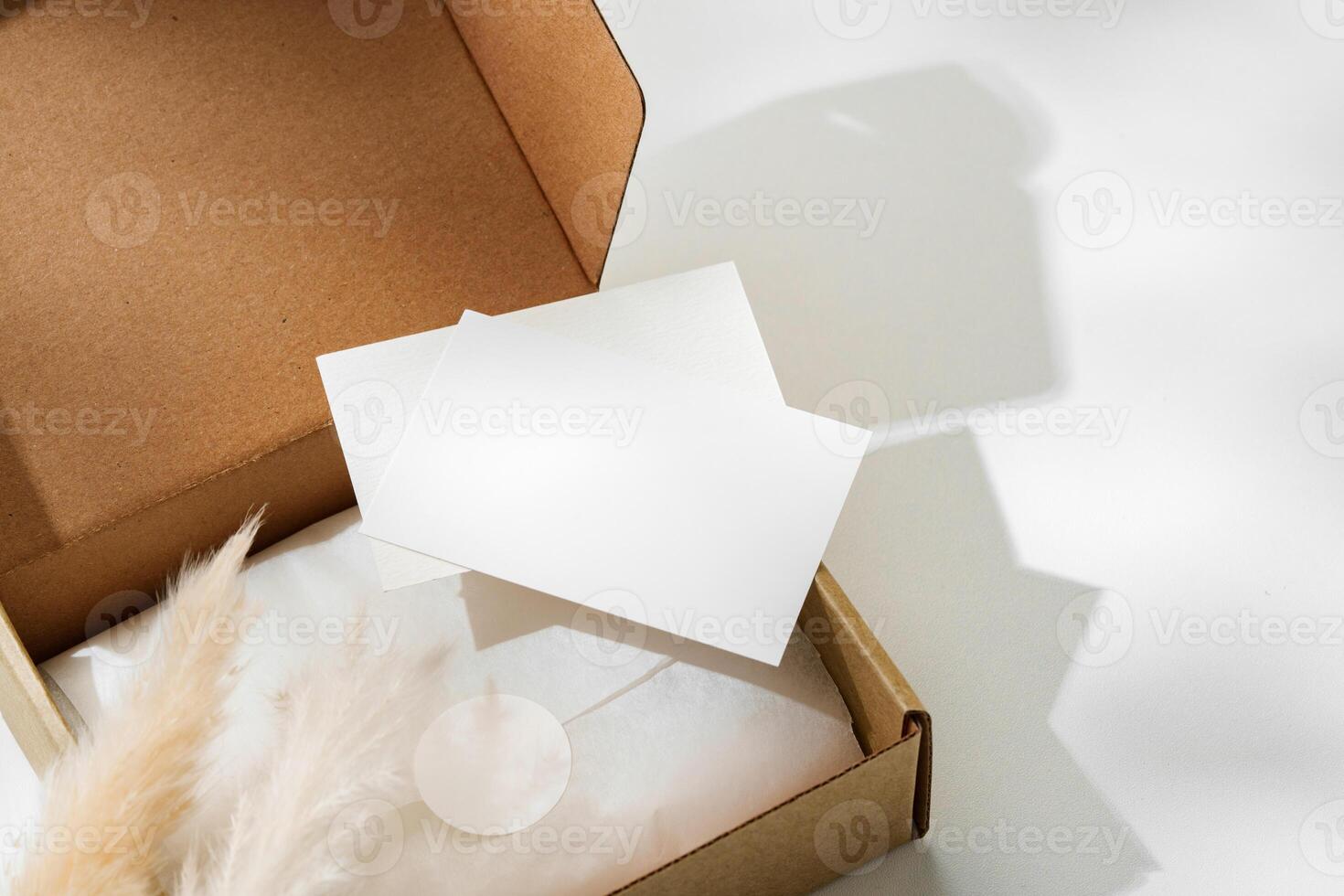 Delivery package with a blank envelope and decorative elements on a light background photo