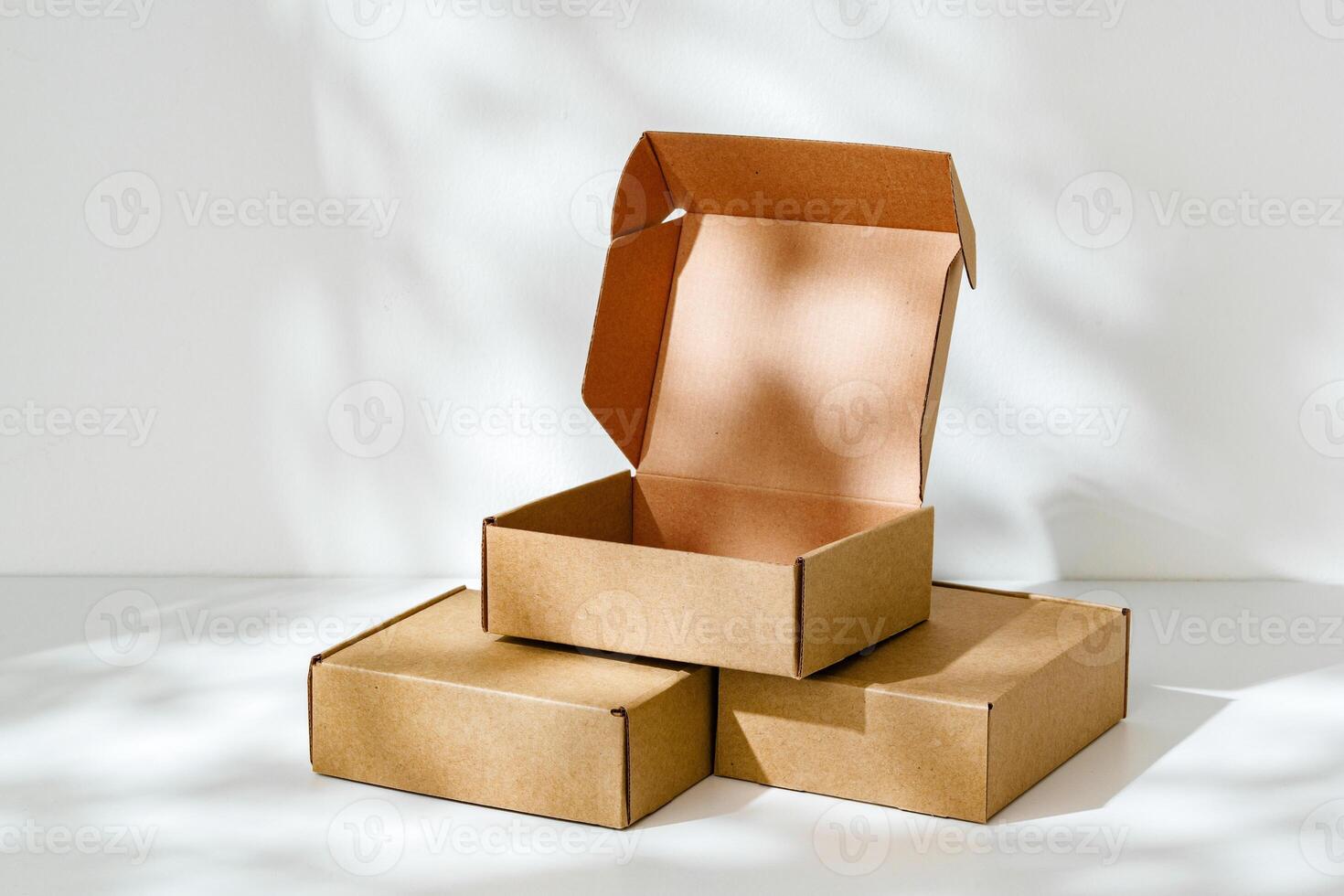 Display of brown cardboard boxes arranged uniquely with one box opened photo