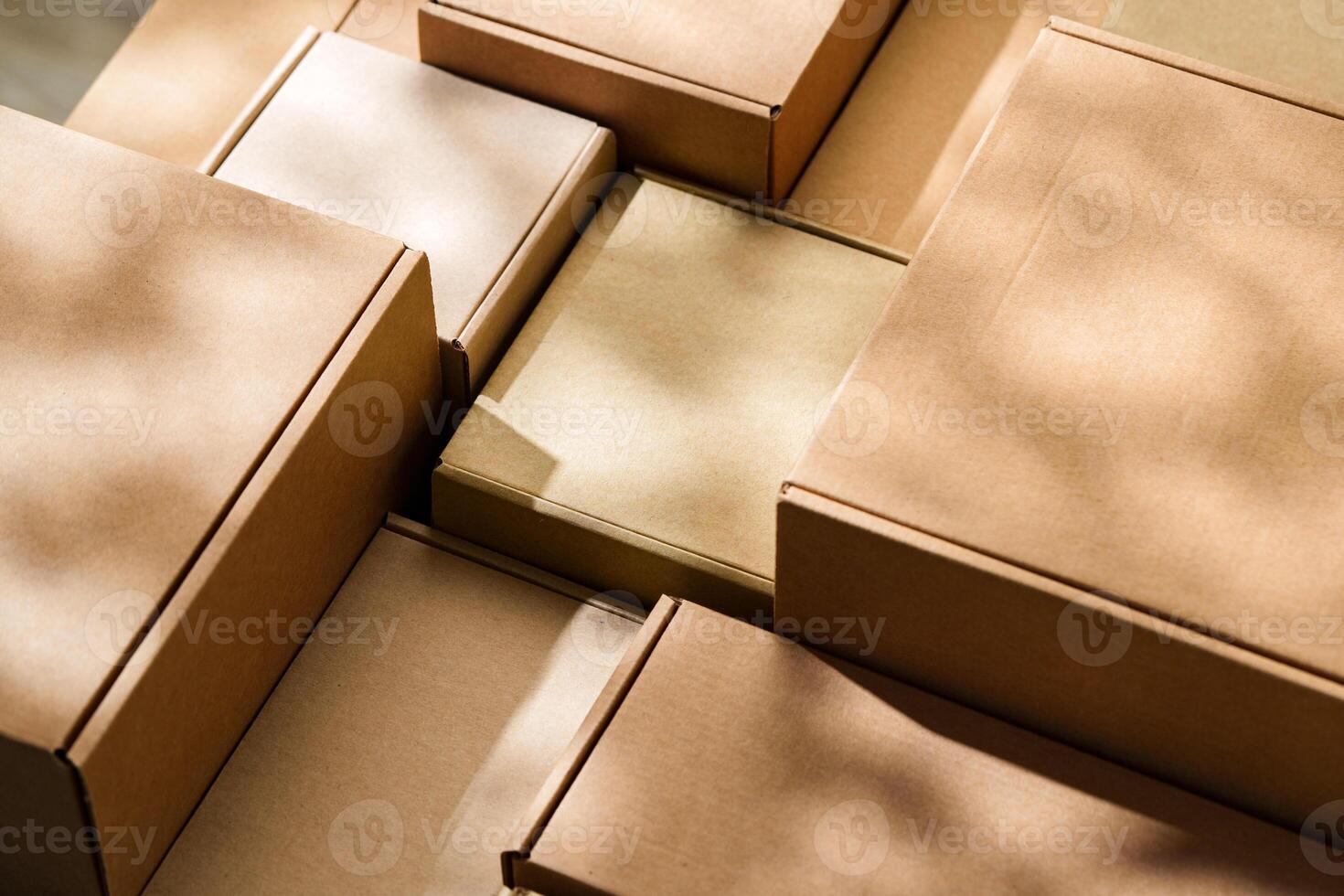 Stacked cardboard boxes arranged in a neat pattern under natural light photo