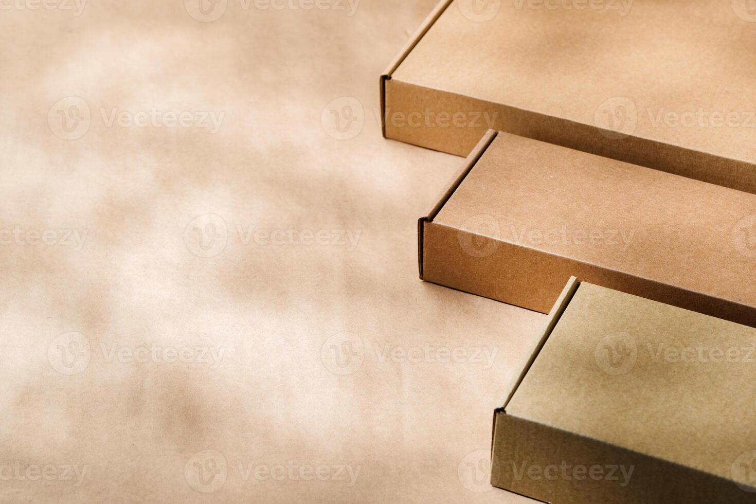 Brown cardboard boxes arranged on a neutral background in a warehouse setting during daylight hours photo