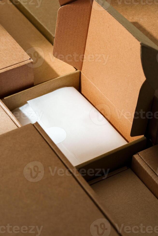 Stacked cardboard boxes arranged in a neat pattern under natural light photo