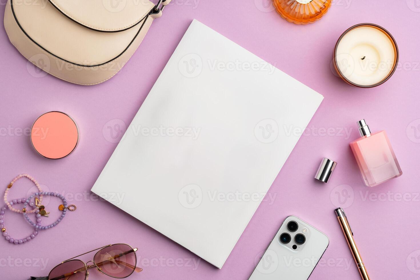 Colorful accessories and a smartphone arranged stylishly on a pastel pink surface photo