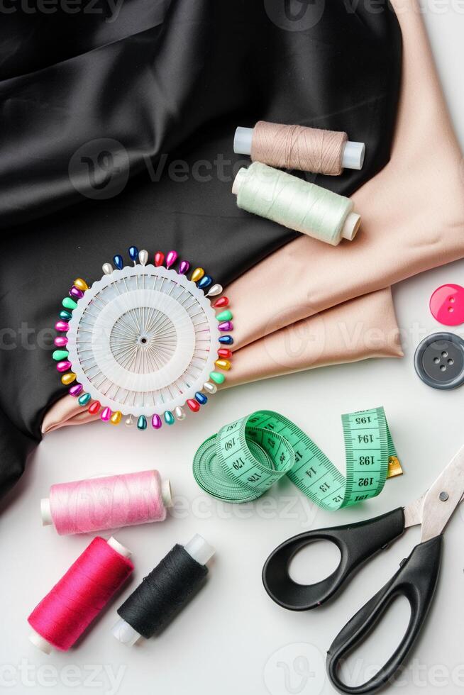 Crafting essentials for sewing projects displayed on a table with fabric, threads, and tools photo