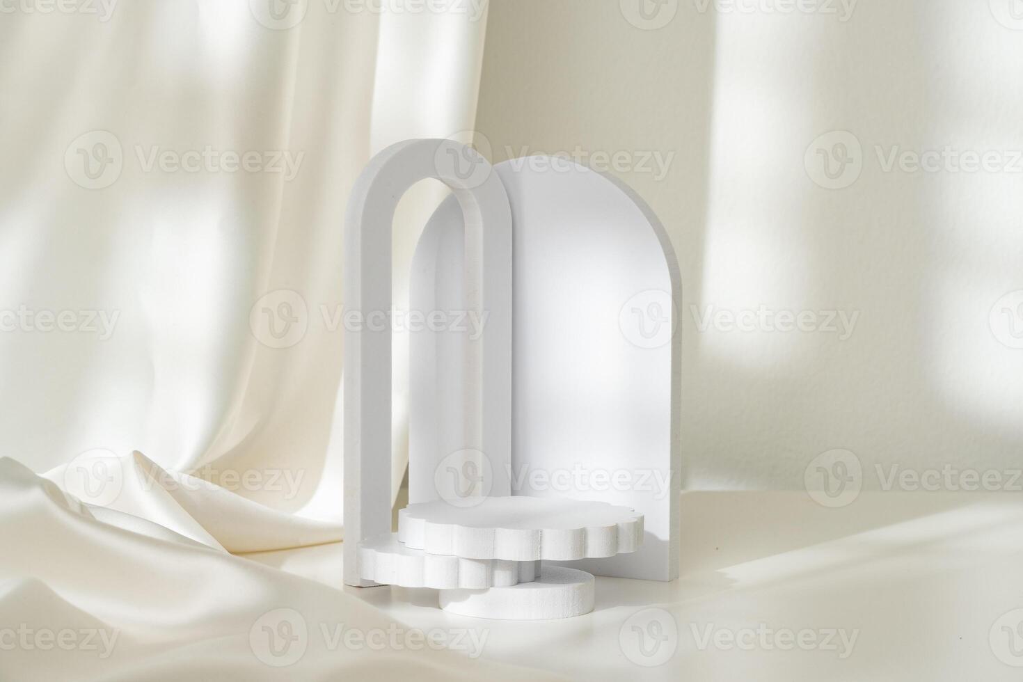 Modern Minimalist White Sculpture Displayed on Soft Draped Fabric in Natural Light photo