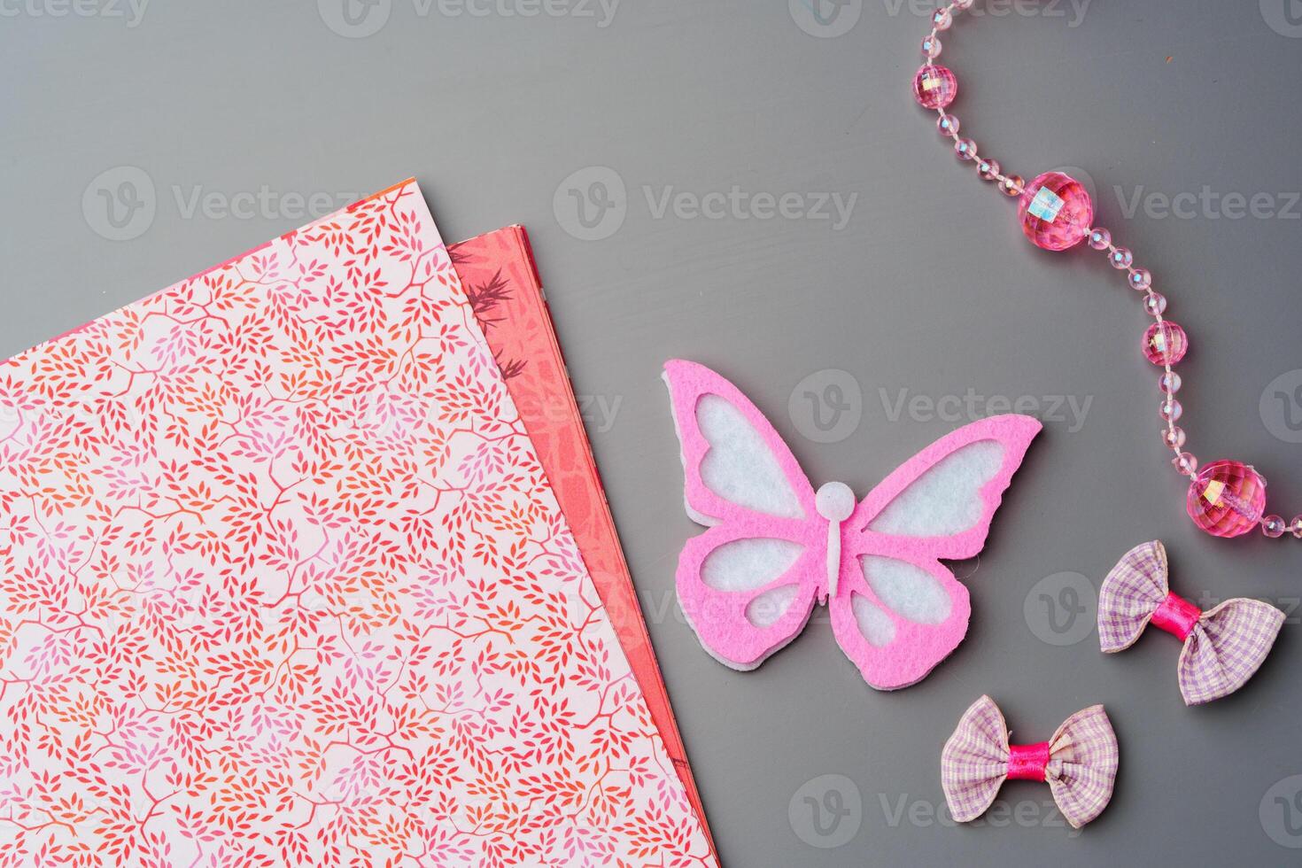 Crafting materials and tools arranged on a gray surface during a creative project photo