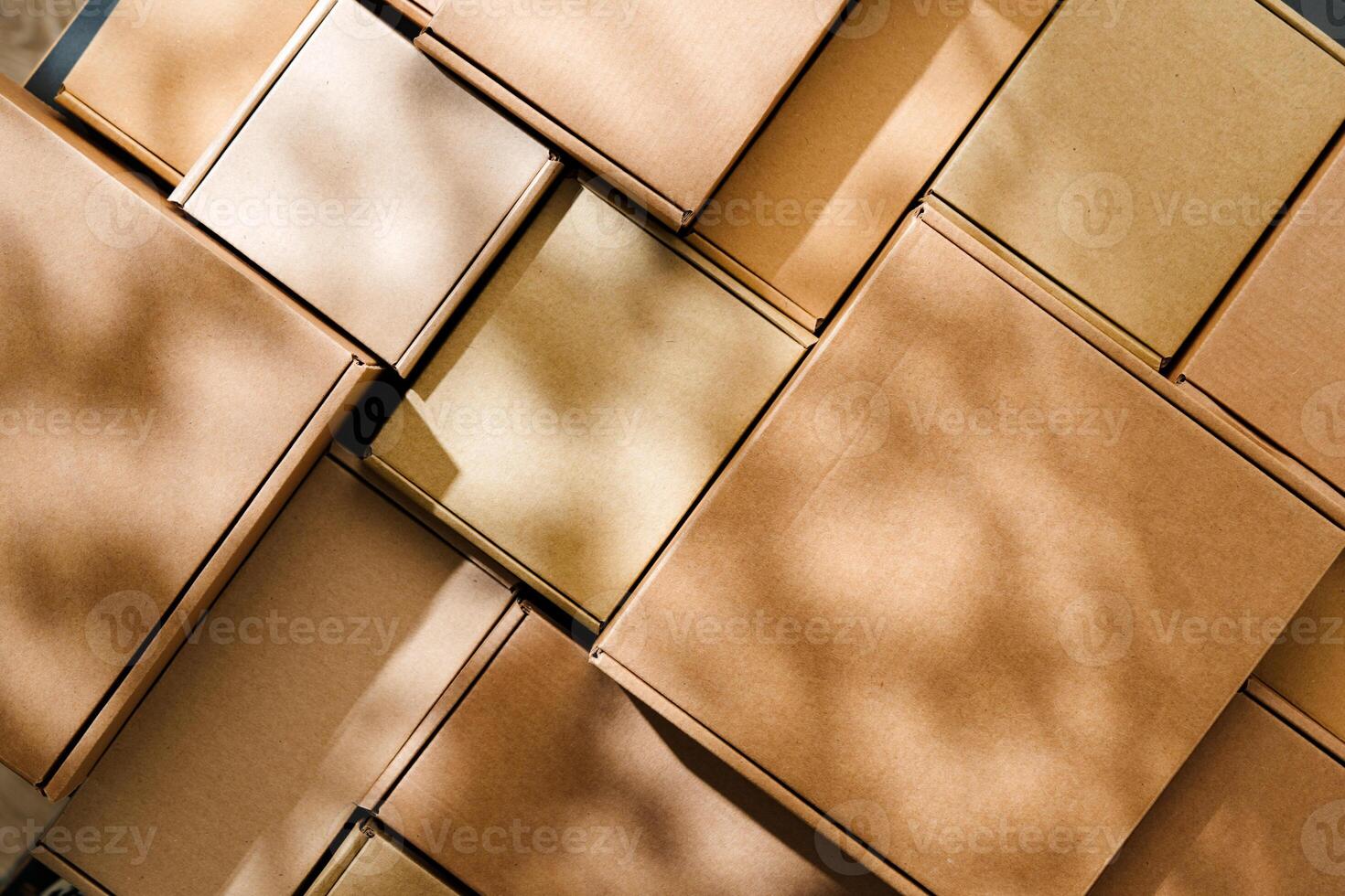 Stacked cardboard boxes arranged in a neat pattern under natural light photo