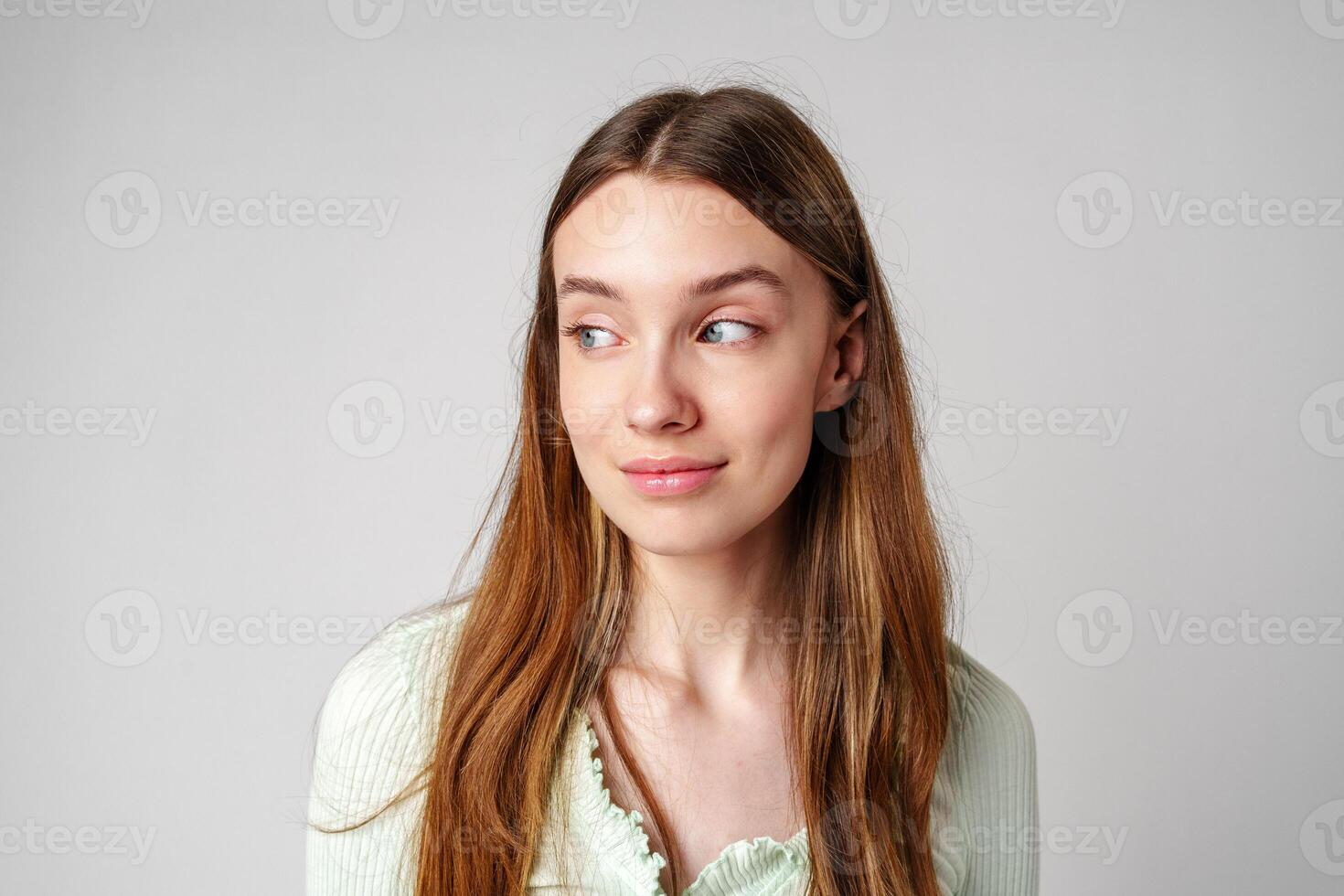 Smiling Young Woman Against White Background in Studio photo