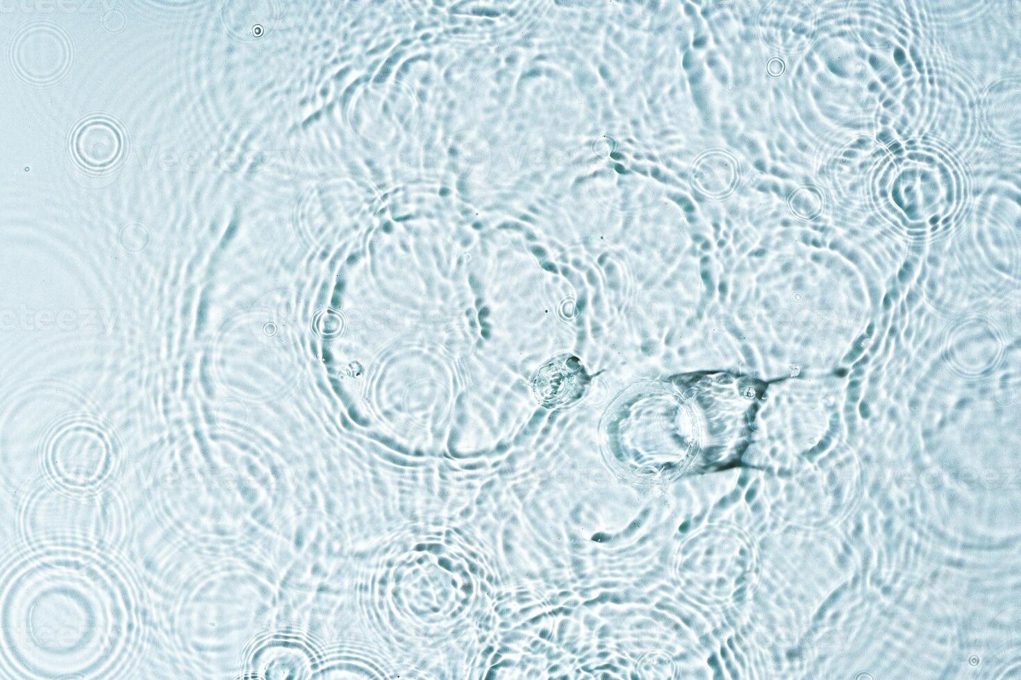 Gentle ripples form on a serene blue surface photo