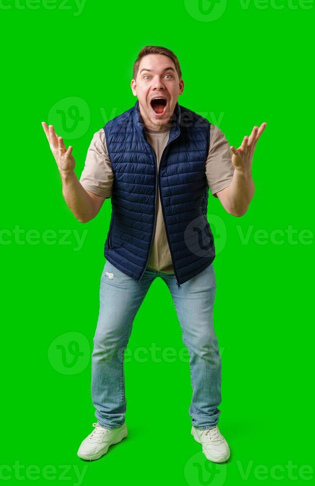 Man celebrating with raised fists in front of a bright green background photo