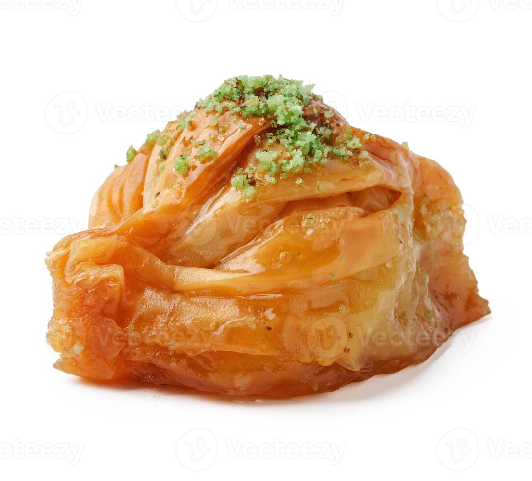 Delicious baklava topped with pistachio and honey, served as a dessert in a traditional setting photo