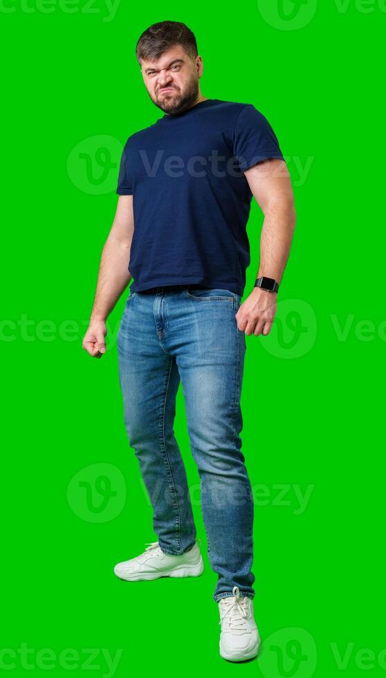 Man expressing confusion with crossed arms in front of a bright green background photo