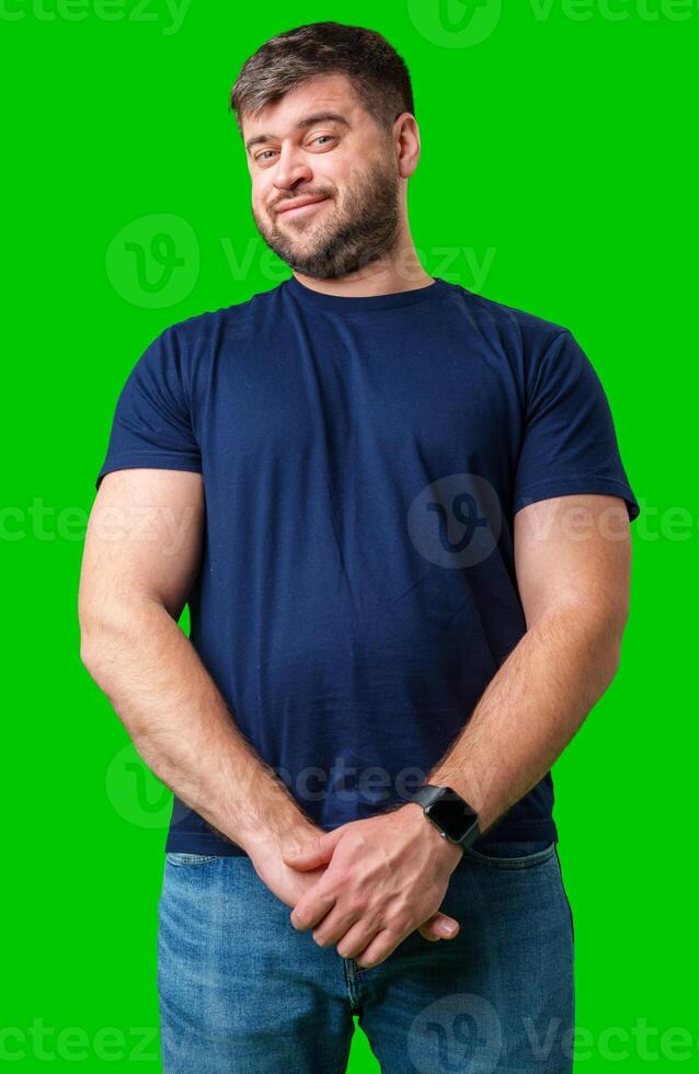 Man standing with a thoughtful expression in a casual outfit against a green background photo
