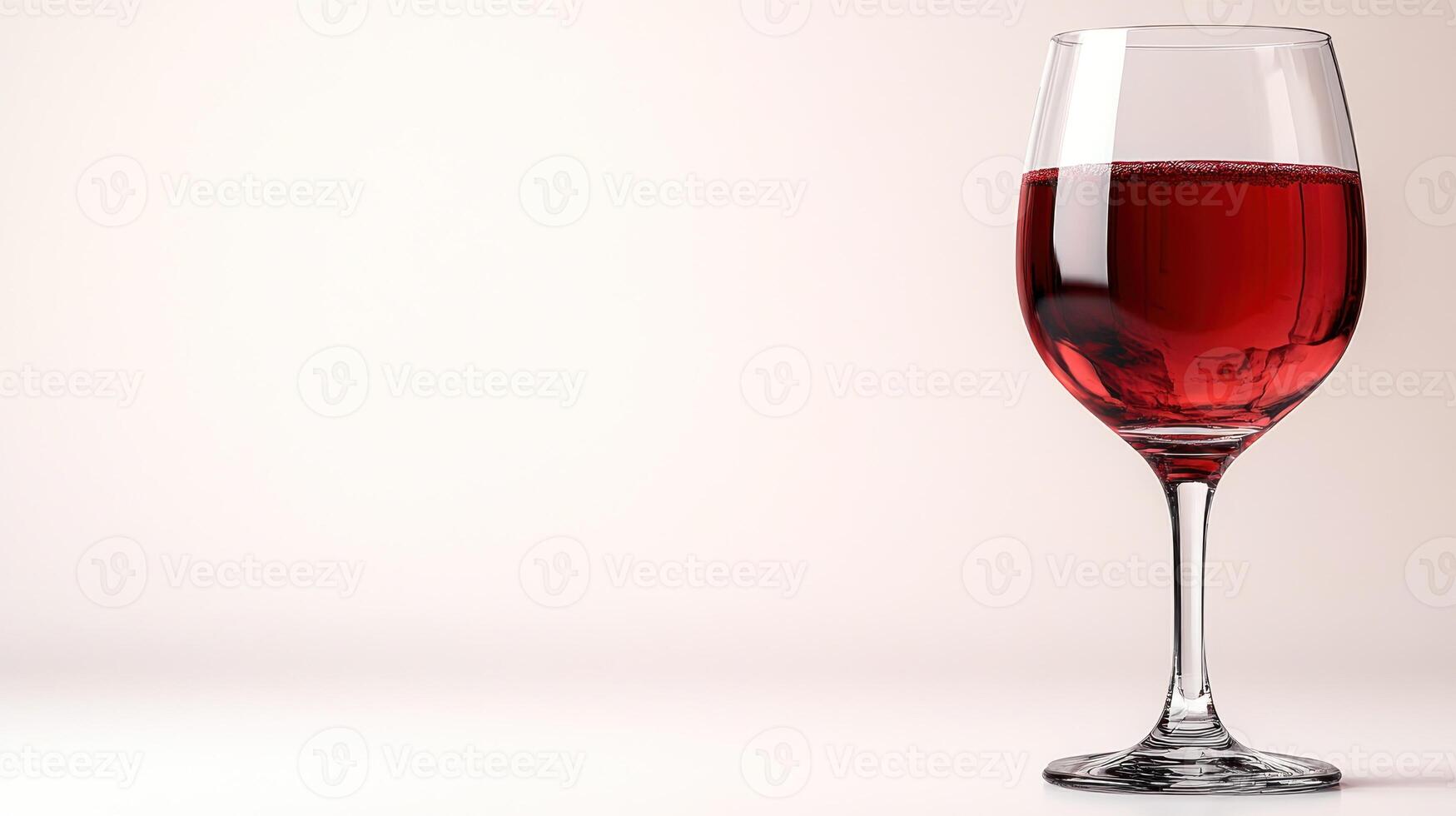 A stunning glass of red wine captures the light, inviting indulgence and relaxation photo