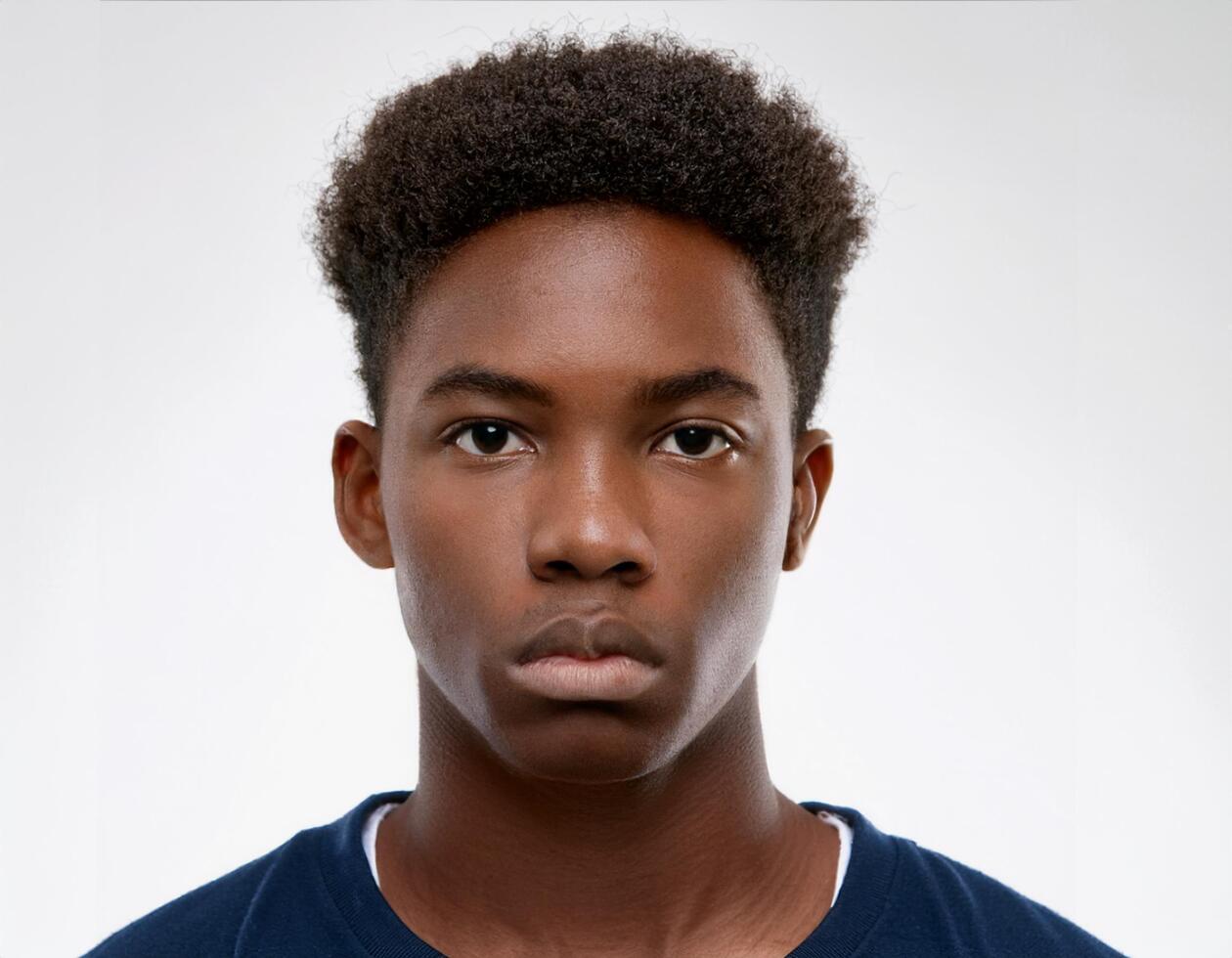 Portrait of African Teenager with Shaggy Hairstyle and Expression on White Background photo