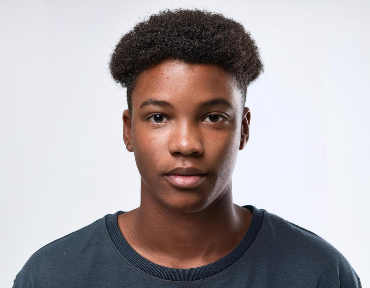 Close Up Portrait of African Teenager with Side Parted Natural Curls on White Background photo