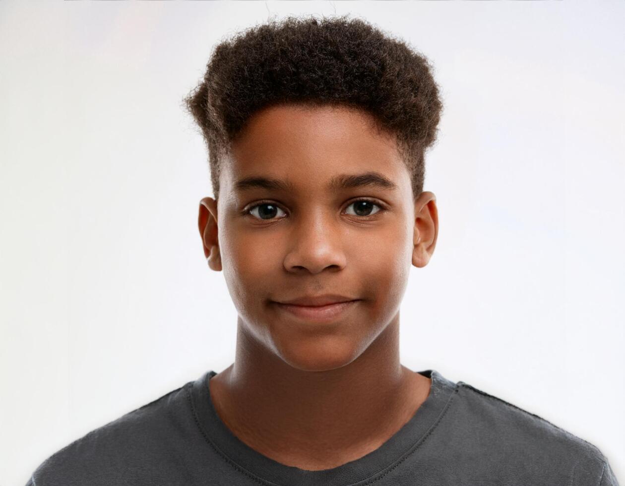 Close Up Portrait of African Teenager with Defined Mohawk Hairstyle on White Background photo