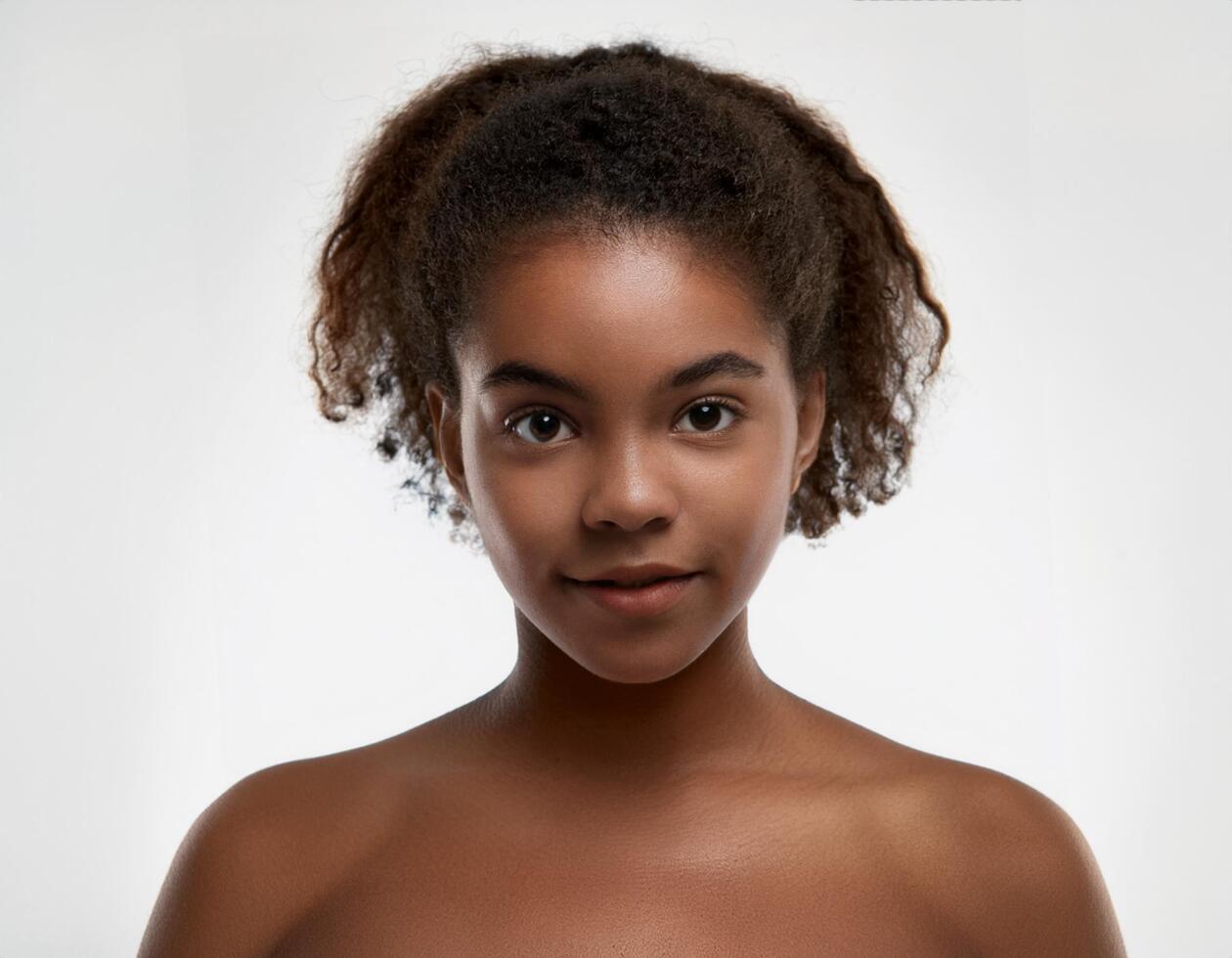 Portrait of African Teenager with Defined Defined Soft Curly Texture on White Background photo