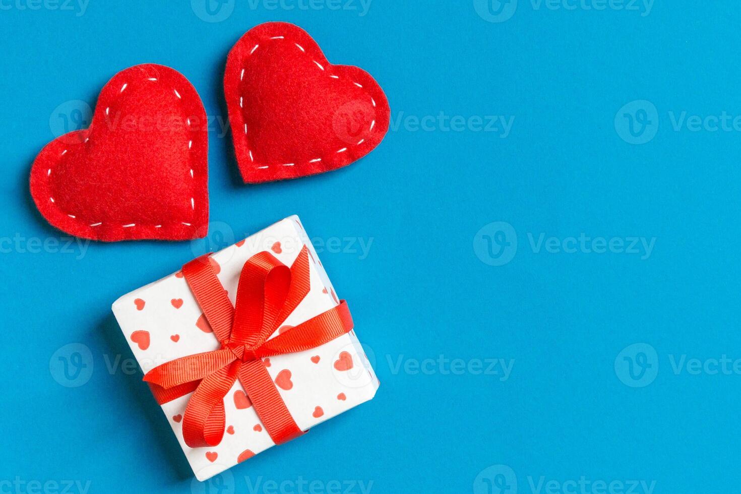 Top view of gift boxes and red textile hearts background. day concept with copy space photo
