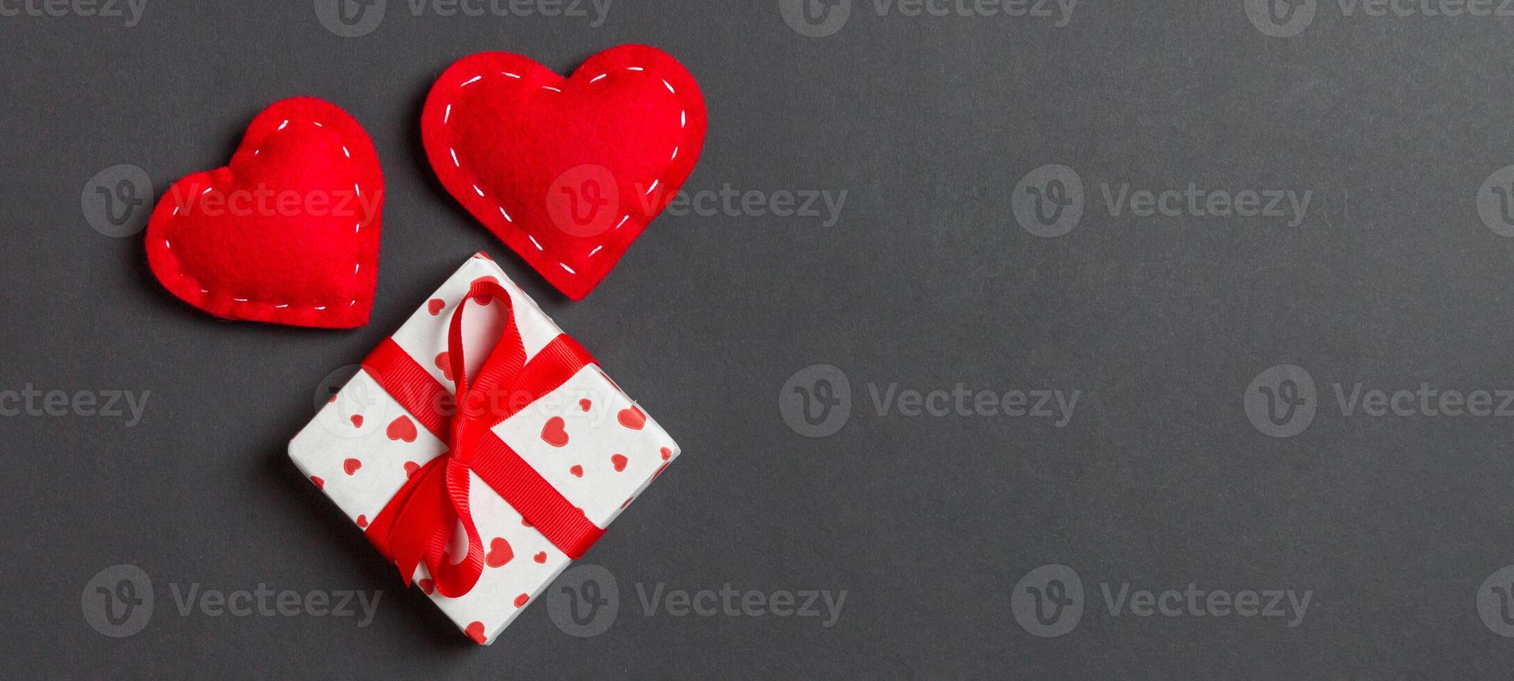 Top view of gift boxes and red textile colorful background. St Valentine's day concept with copy space photo