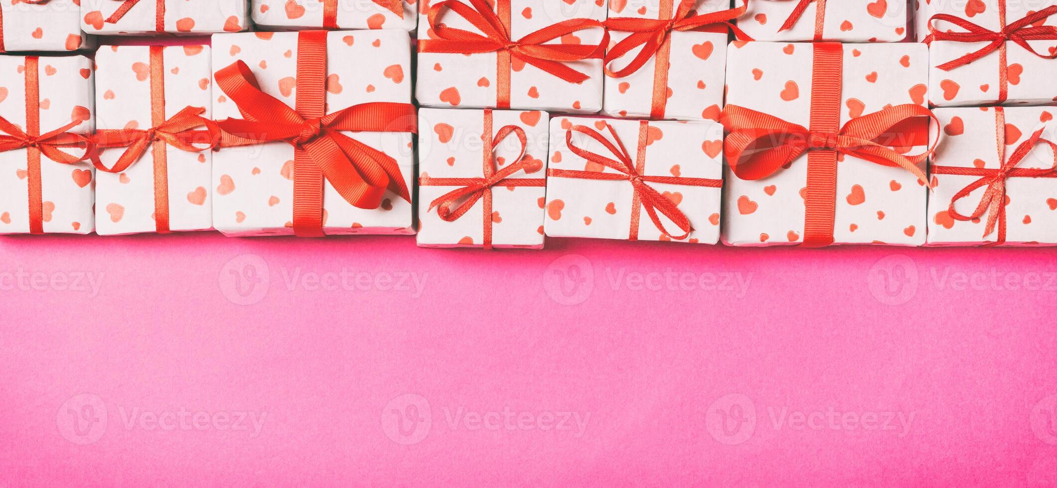 Holiday composition of gift boxes with hearts on colorful background with empty space for your design. Top view of Valentine's Day concept photo