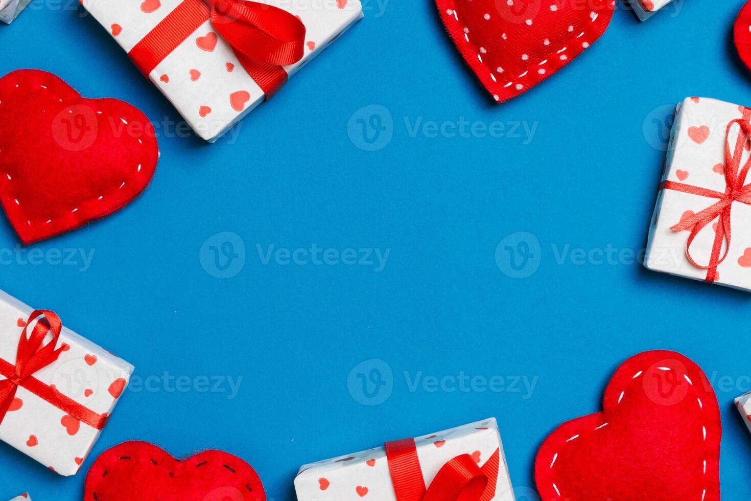 Top view of festive gift boxes and red textile hearts with copy space. St Valentine's day concept photo