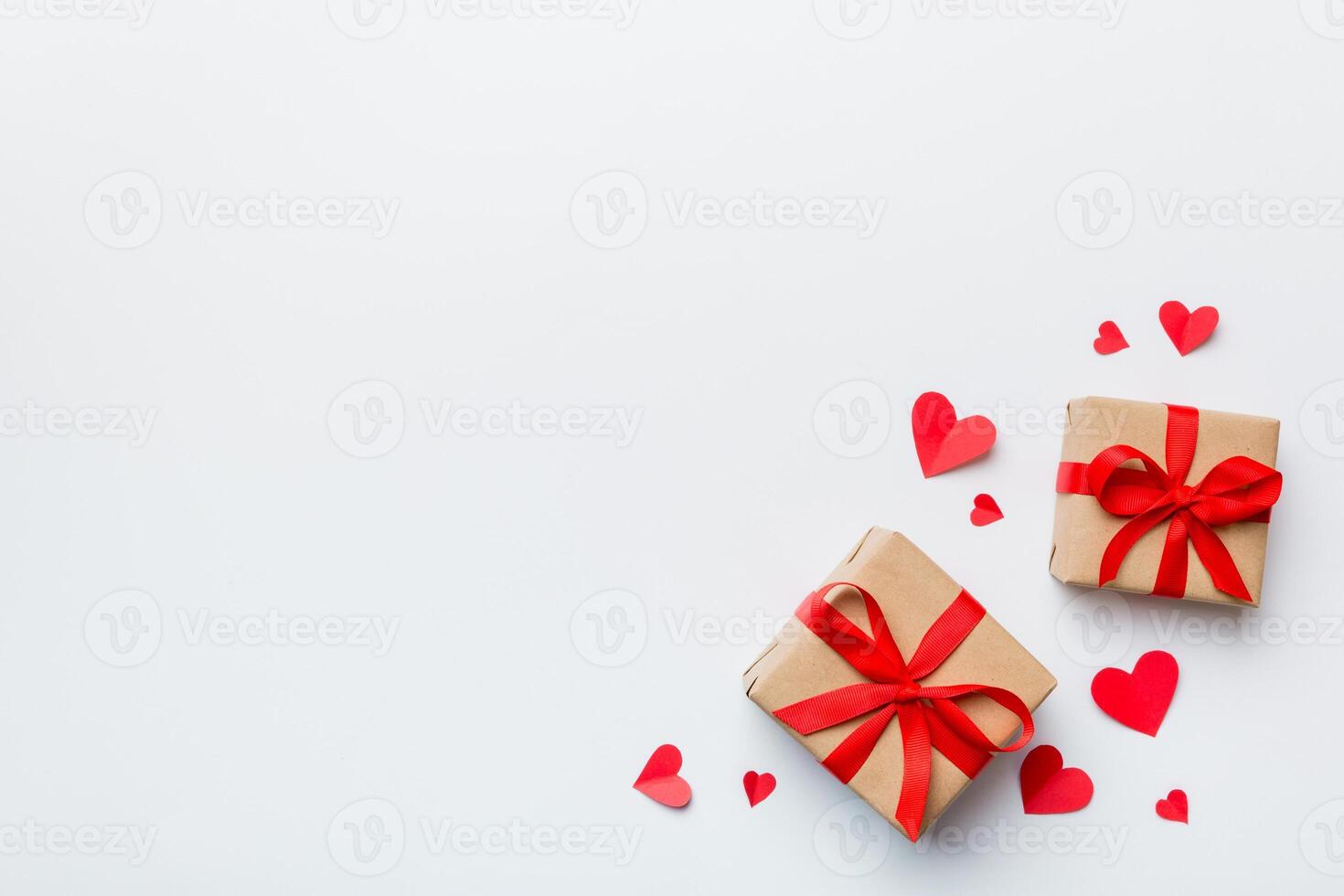 Valentine day composition red gift box with bow and heart. View from above. Space for text. Holday greeting card photo