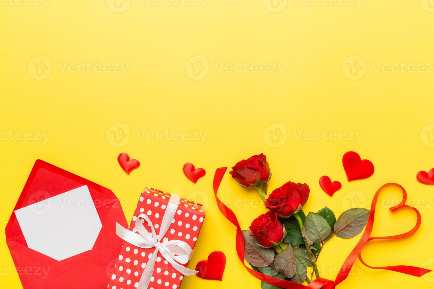 Valentine day composition with Envelope rose and Red heart on table. Top view, flat lay. Holiday concept photo
