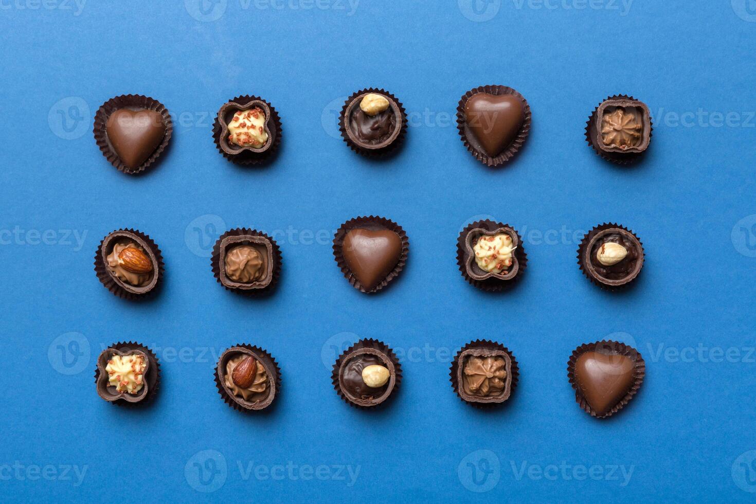 Different kinds of chocolates on colored. Top View and Flat Lay photo