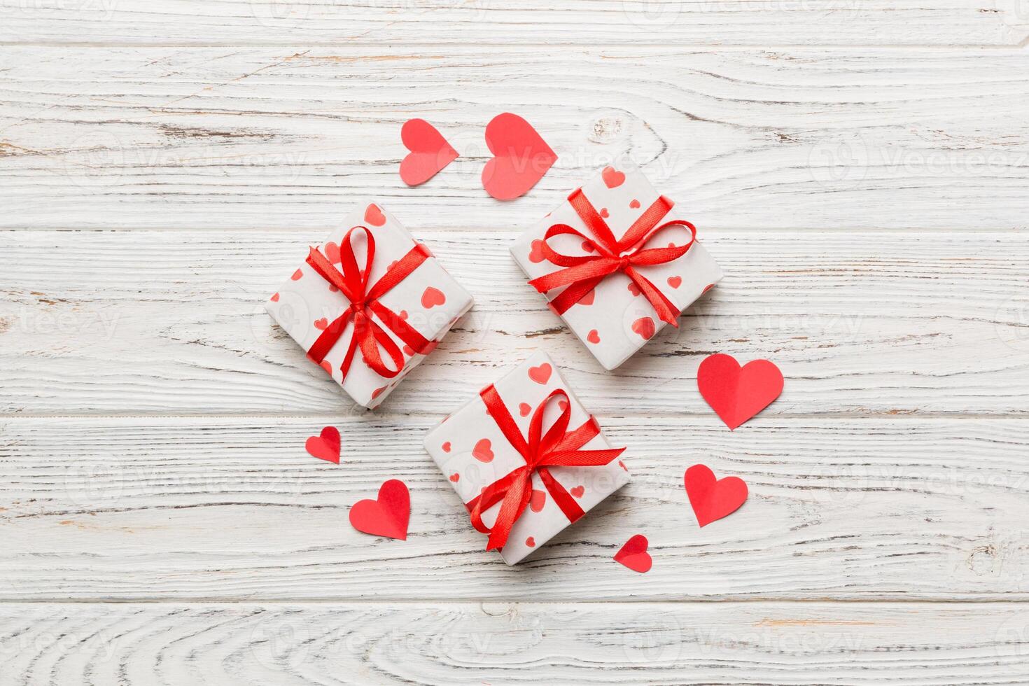 Valentine day composition Background red gift with bow and heart. Christmas present. View from above. Holday greeting card photo
