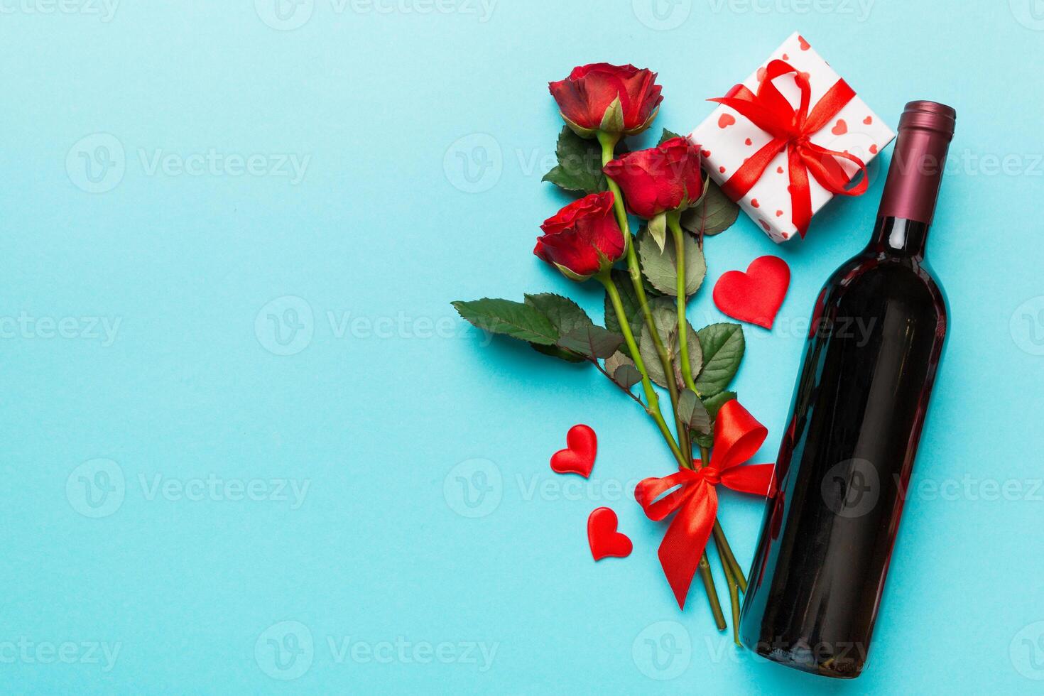 Valentine's day composition with red wine rose flower gift box on table. Top view, flat lay. Holiday concept photo