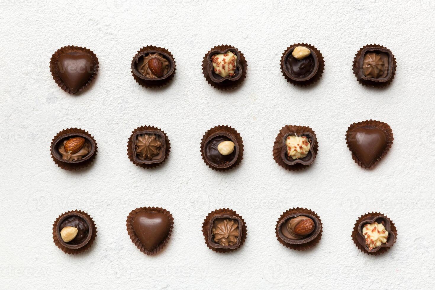 Different kinds chocolates on colored table close-up. Top View photo