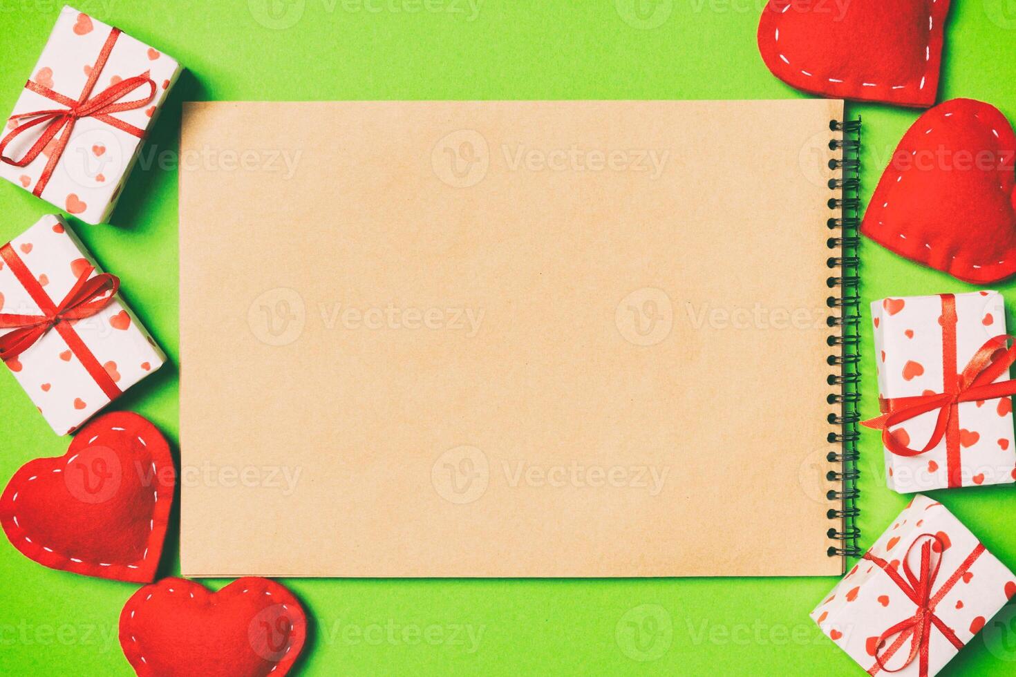 Top view of craft notebook surrounded with gift boxes photo