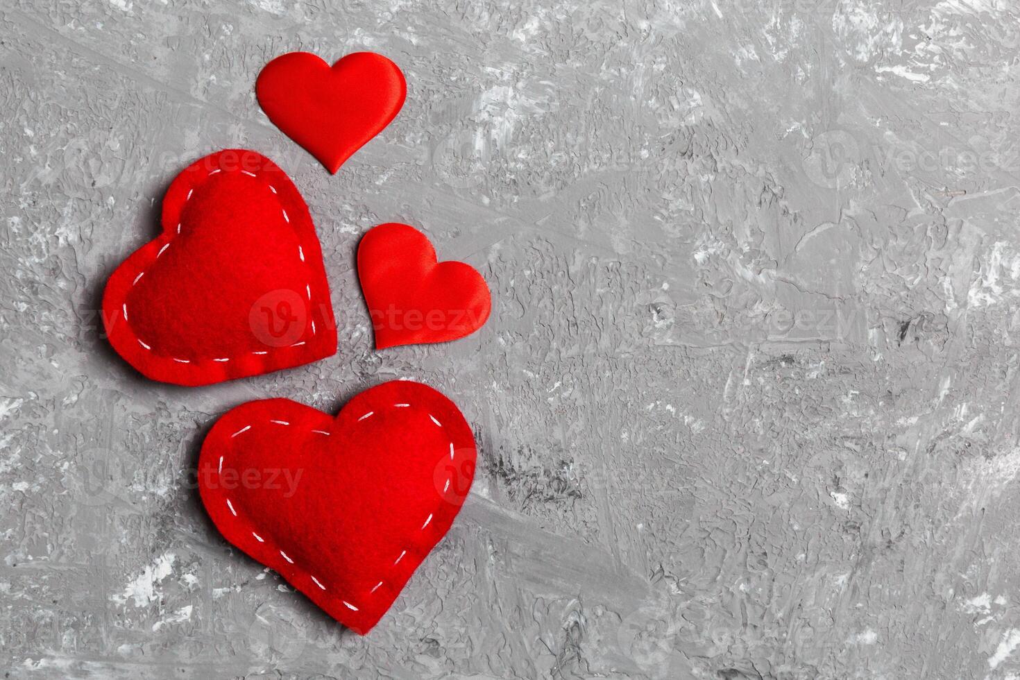 Top view composition of red hearts on cement background. Romantic relationship concept. Valentaine's Day photo