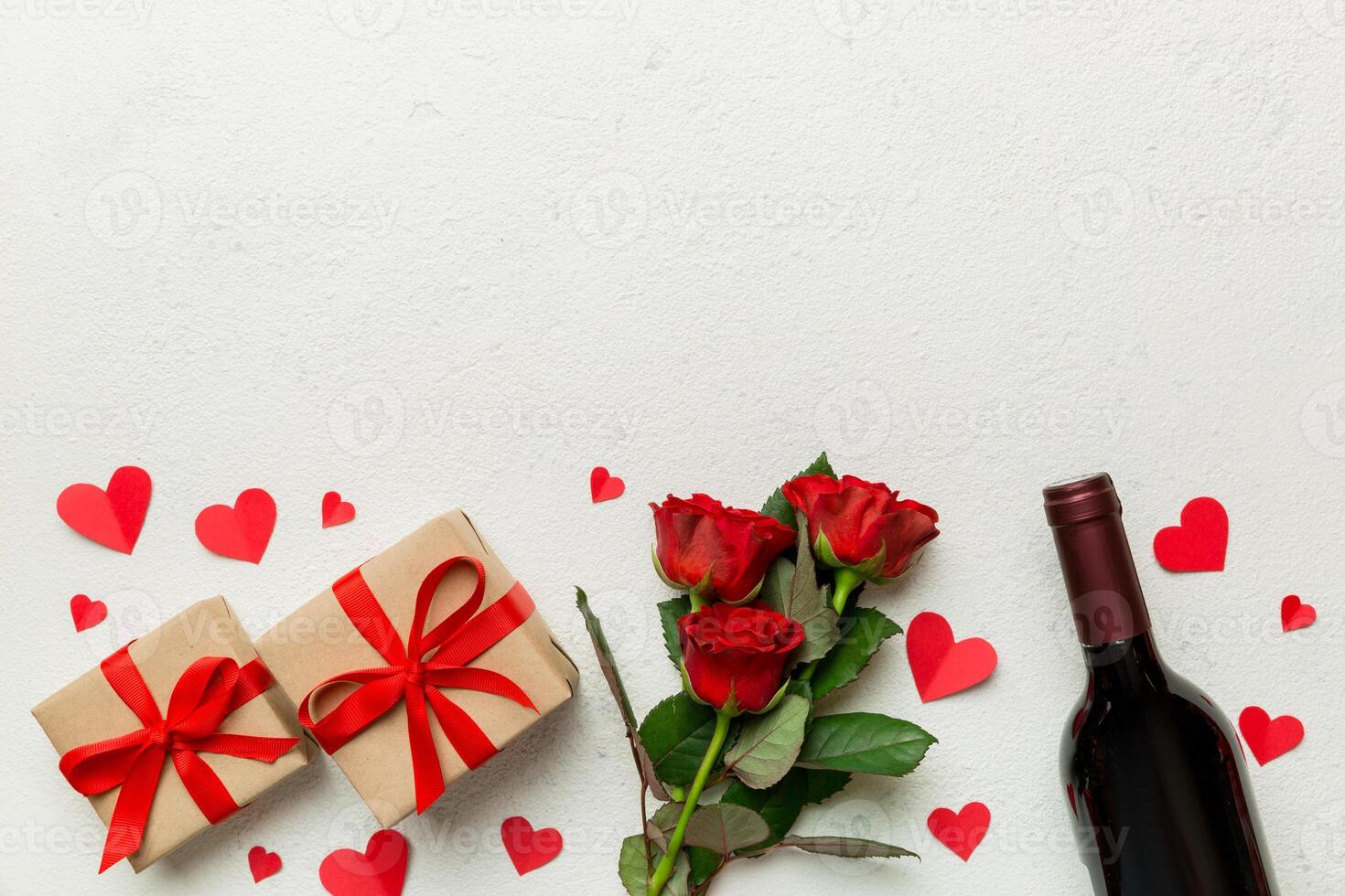 Valentine's day composition with red wine, rose flower gift box on table. Top view, flat lay. Holiday concept photo