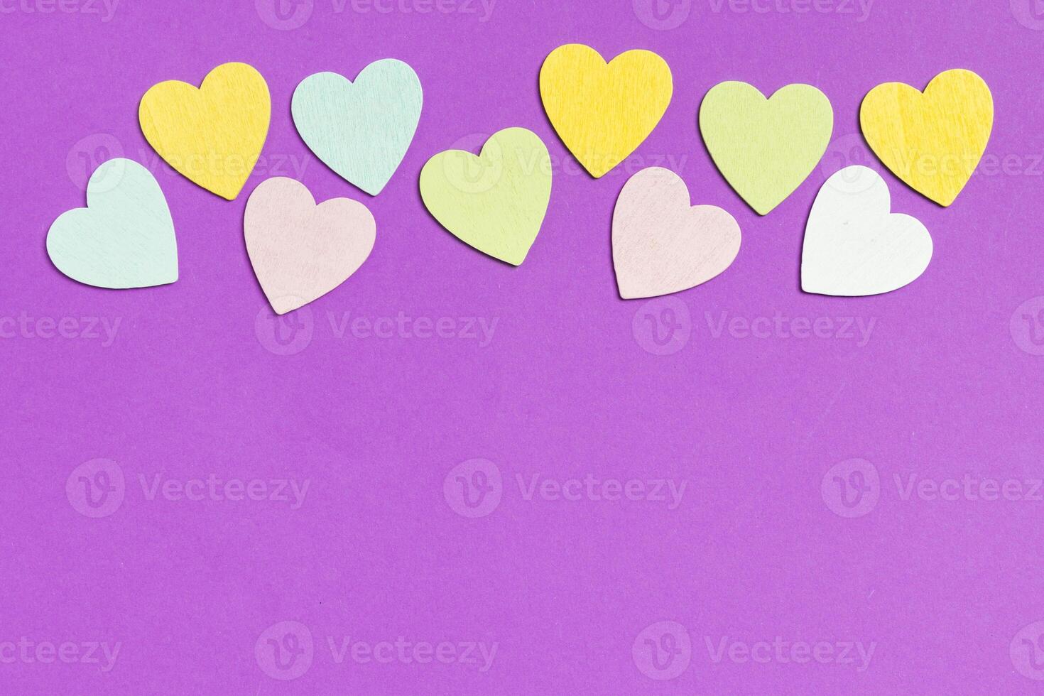 Top view of wooden hearts on colorful background copy space. photo