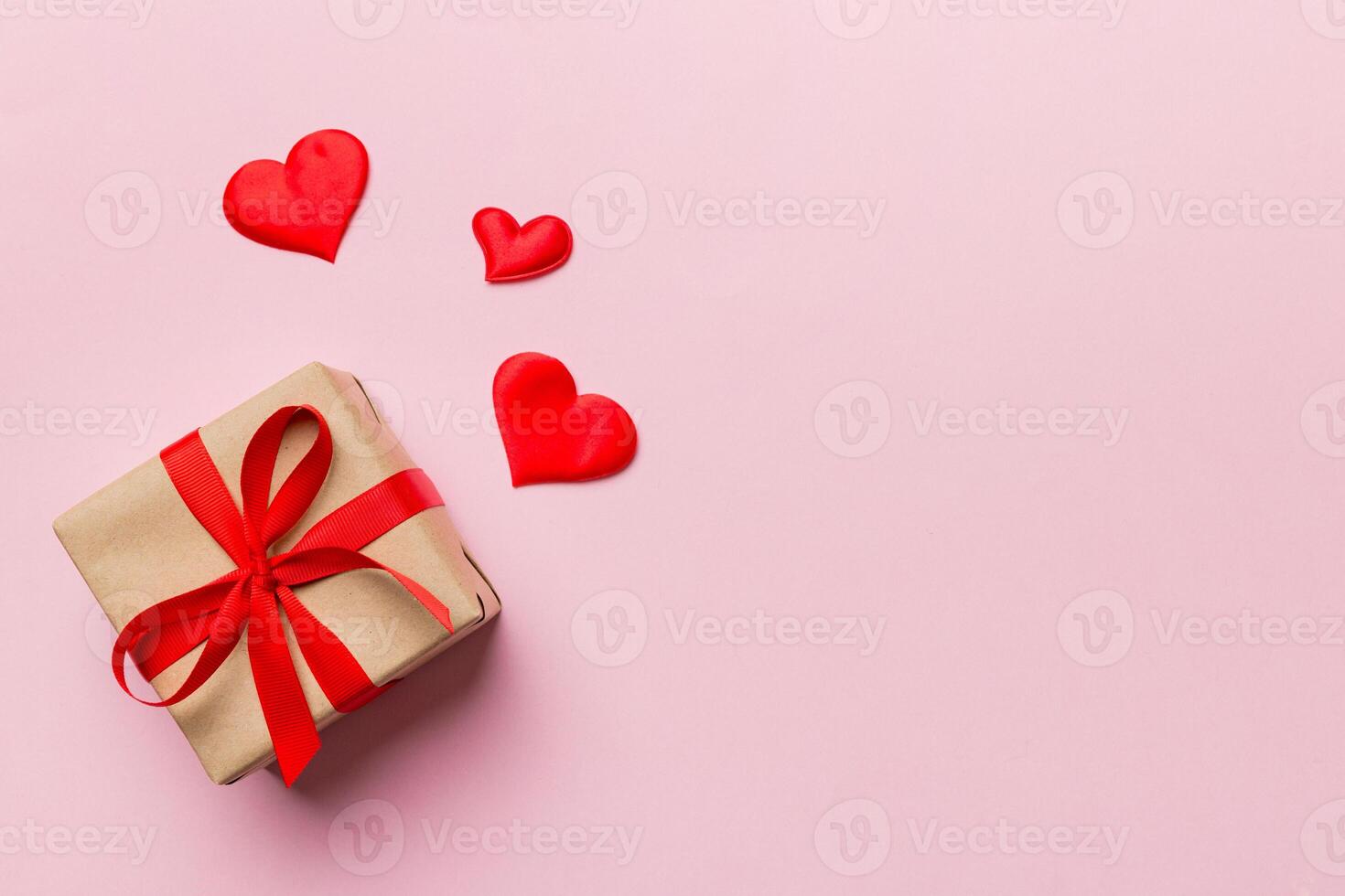 Valentine day red gift box with bow and heart. Christmas . View from above. Space for text. Holday greeting card photo