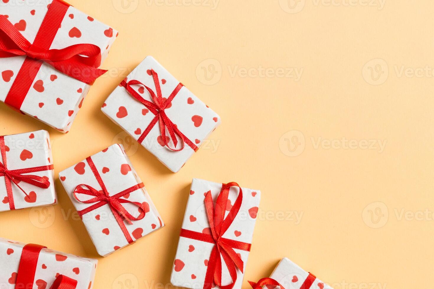 Top view valentine background made of gift boxes with red hearts. Valentine's Day concept with copy space photo