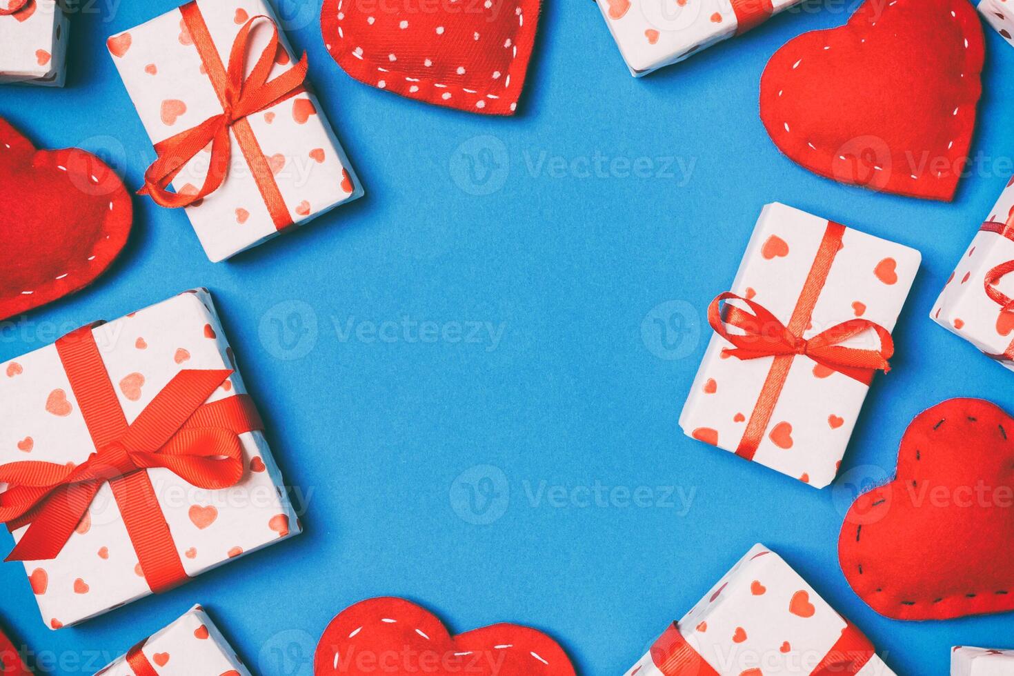 Top view of festive gift boxes and red textile hearts on background with copy space. St Valentine's day concept photo