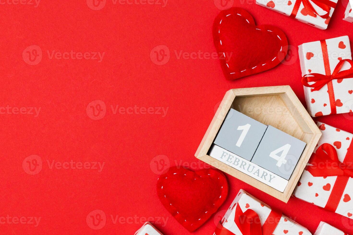 Top view of gift boxes, wooden and red textile hearts on colorful background. The fourteenth of february. St Valentine's day concept with copy space photo