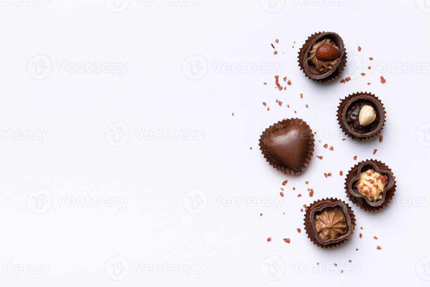 Different kinds of chocolates on colored table closeup. Top View and Flat Lay with copy space photo