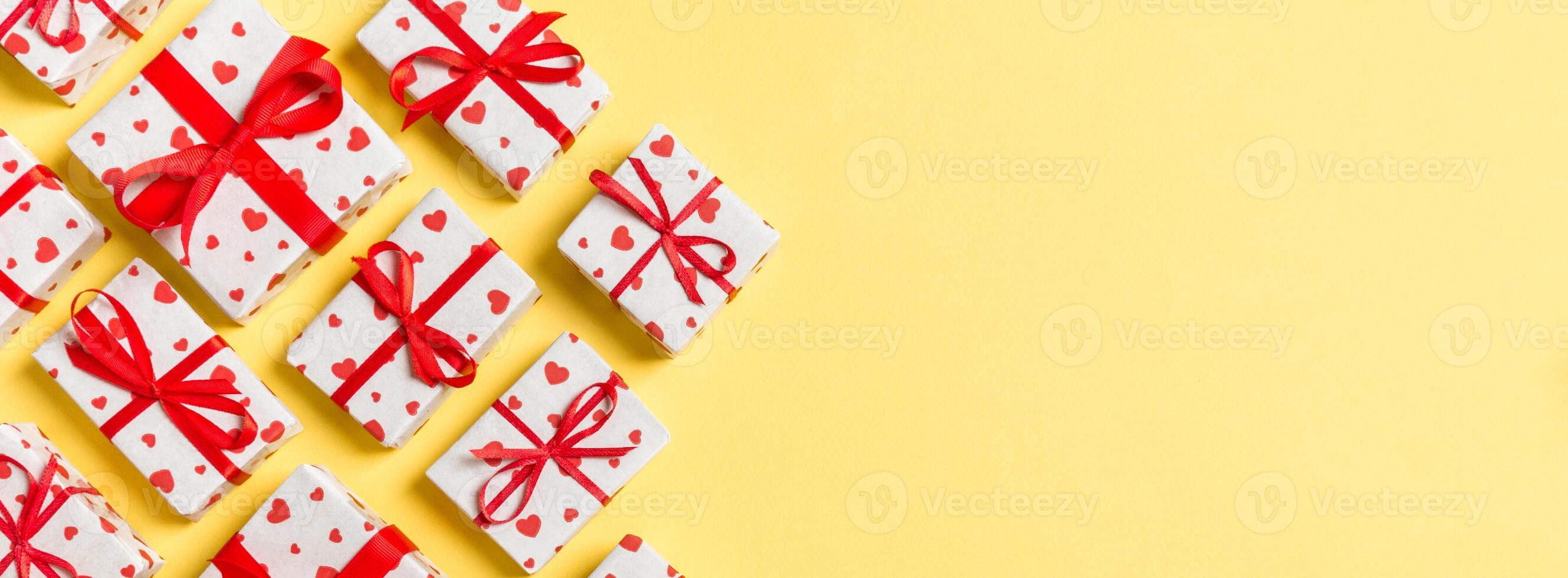 Top view gift boxes with red hearts on colorful background. St Valentine's day concept with copy space photo