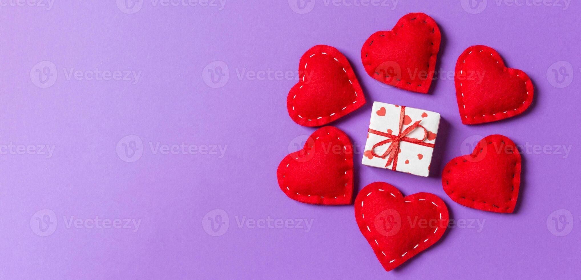 Holiday composition gift boxes and red textile hearts on colorful background with empty space for your design. Top view of Valentine's Day concept photo