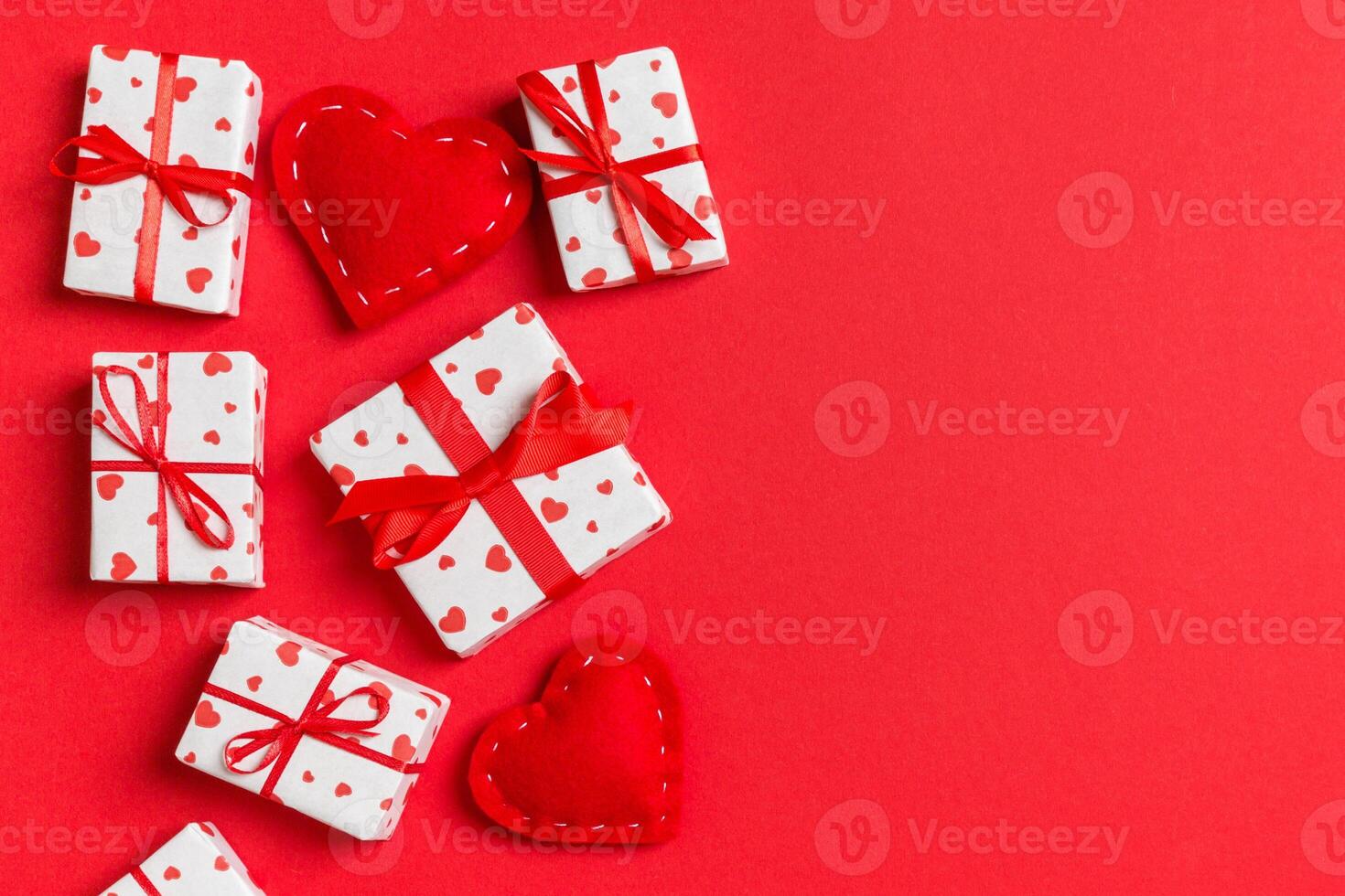 Top view of gift boxes and red textile hearts colorful background. St Valentine's day concept with copy space photo
