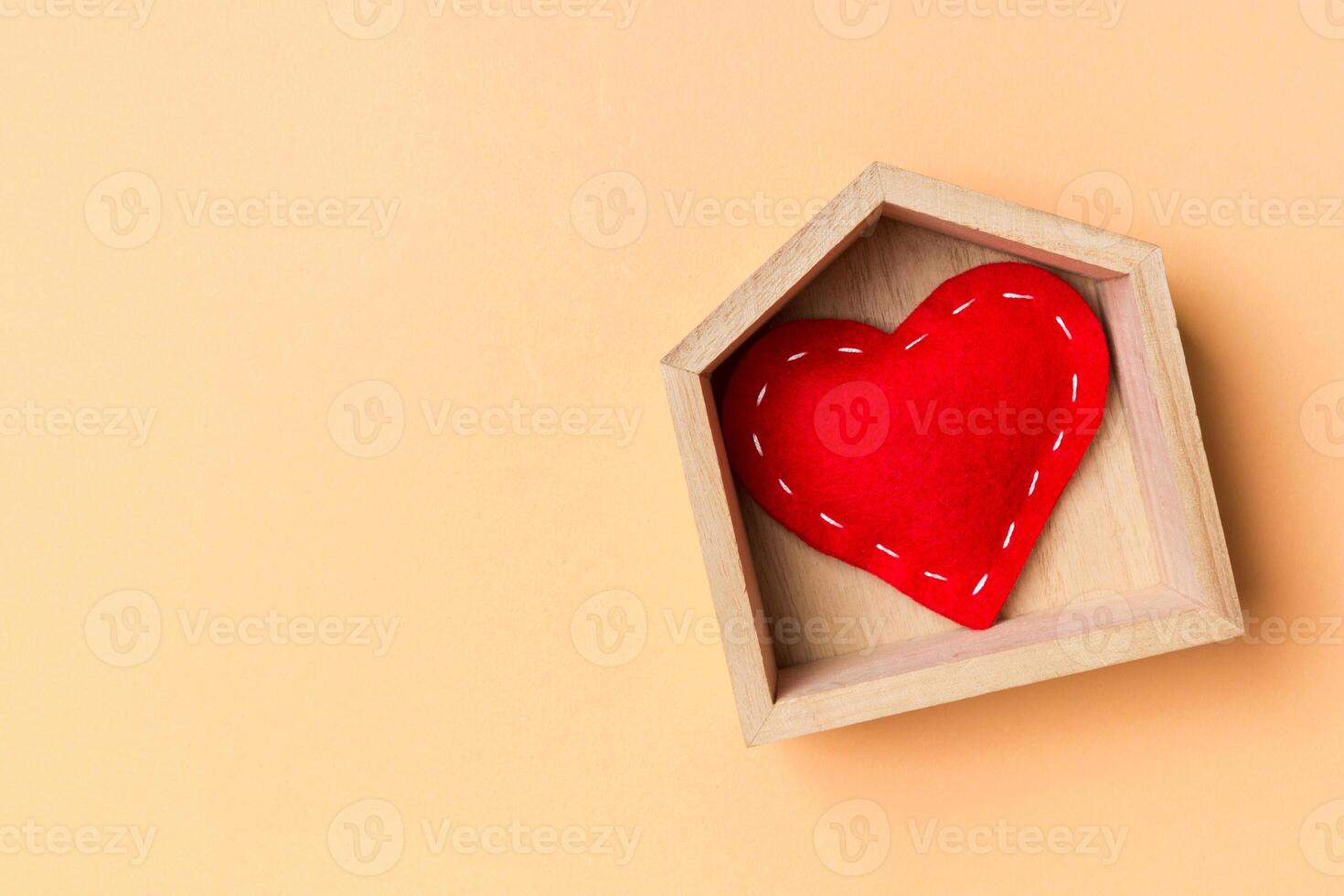 Top view of red textile heart a wooden house on colorful background. Home sweet home concept. Valentine's day photo