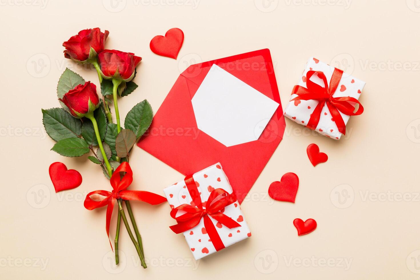 Valentine day composition with Envelope rose flower and Red heart on table. Top view, flat lay. Holiday concept photo