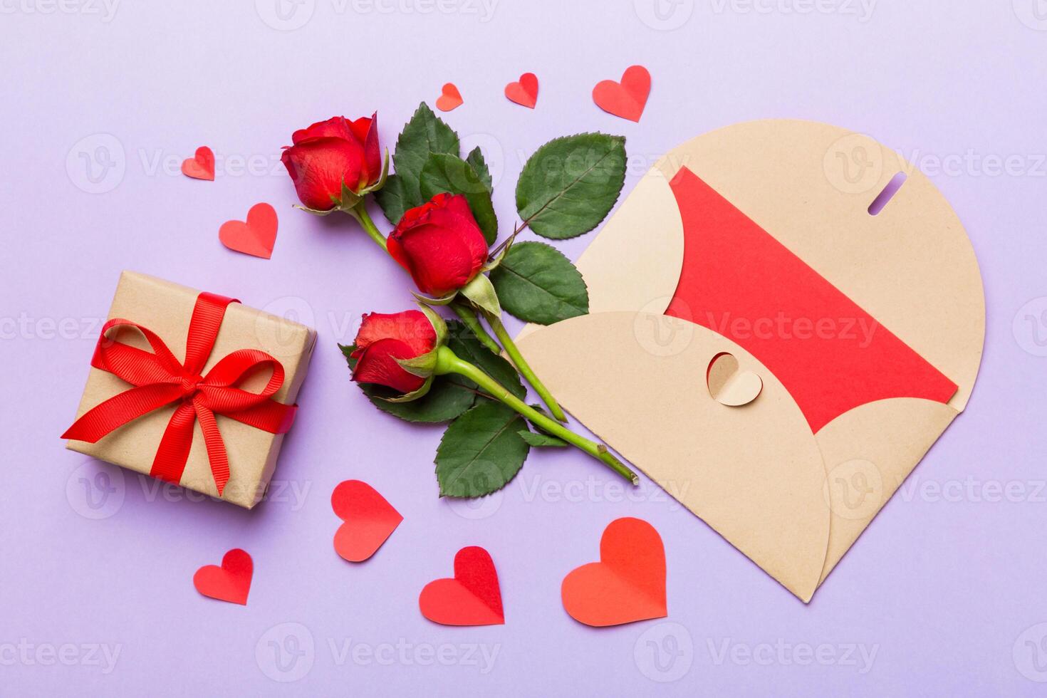 Valentine day composition envelope rose flower and red heart on table. Top view, flat lay, copy space Holiday concept photo